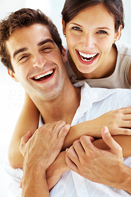 Loving young couple together with arms around