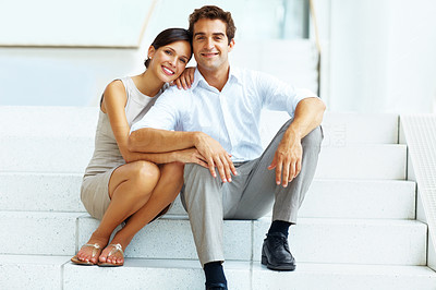 Young couple sitting on steps of a building