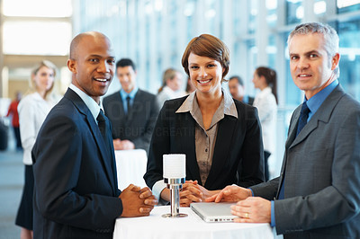 Business colleagues smiling at a conference hall