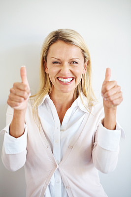 Excited young female showing thumbs up sign