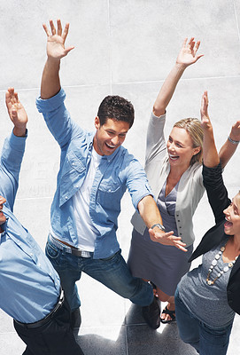 Business success - Group of businesspeople raising hands in joy