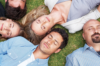 Group of people lying on grass taking a nap