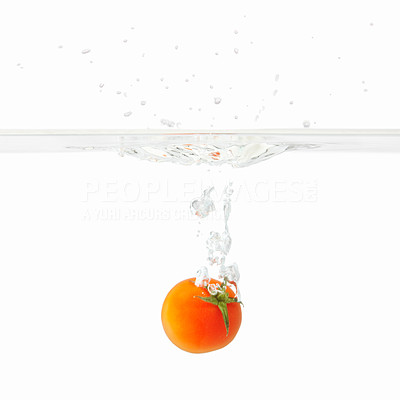 Single tomato dropped into water