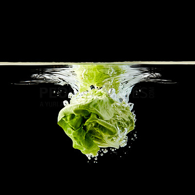 Head of lettuce splashing into water