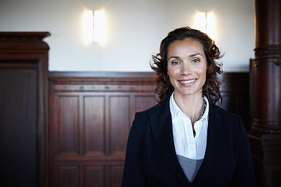Cropped shot of an attractive mature female lawyer standing in a courtroom and smiling
