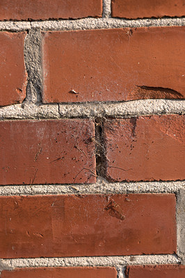 A photo of a very old brick wall with a slider hole