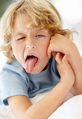 Closeup portrait of a mischief child showing his tongue