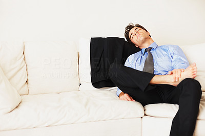 Young business man sleeping on couch at home
