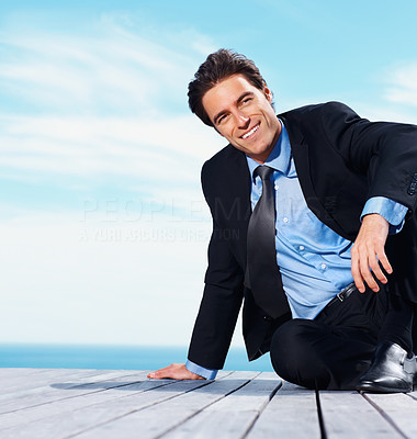 Relaxed business man sitting and smiling over his thought