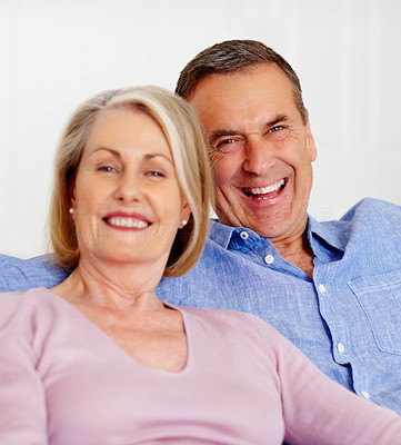 Cheerful mature couple against white background