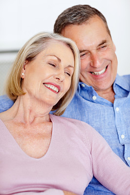 Smiling senior couple together having fun against white