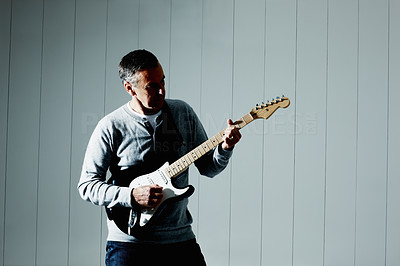Mature musician playing an acoustic guitar - copyspace