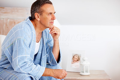 Relaxed mature man in bathrobe looking away - copyspace