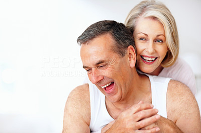 Cheerful couple having fun against white background - copyspace