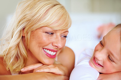 Smiling mother and daughter looking at each other
