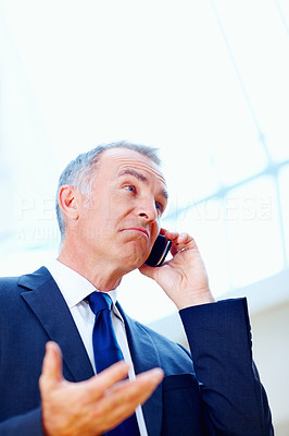 Executive looking uncertain while on phone