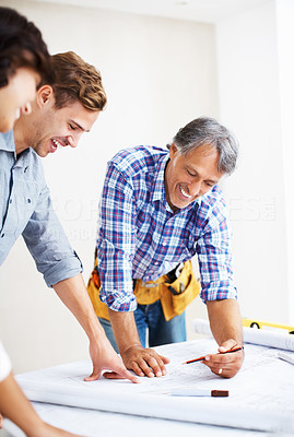 Couple discussing home renovation plan with architect