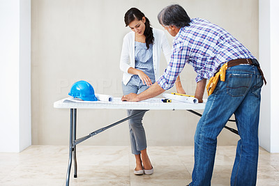 Attractive woman discussing home renovation with architect