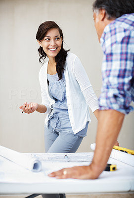 Happy woman discussing home renovation plans with architect