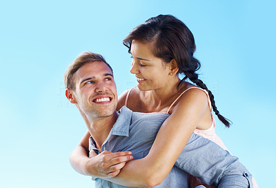 Loving man carrying woman on back