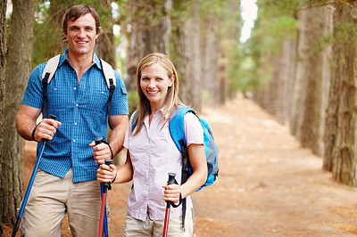 Hiking couple standing in the woods and smiling