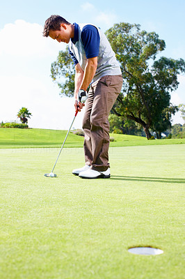 Golfer about to putt the ball