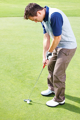 Male golfer ready to putt the ball