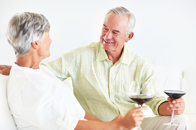 Mature couple drinking wine on couch