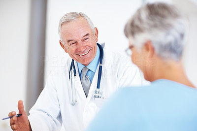 Cheerful doctor discussing medical report with patient
