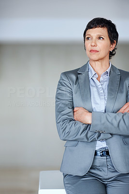 Female executive thinking in office