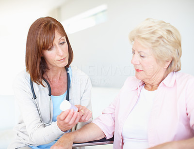 Professional nurse prescribing to her elderly patient