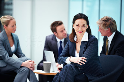 Smiling business woman with executives conversing