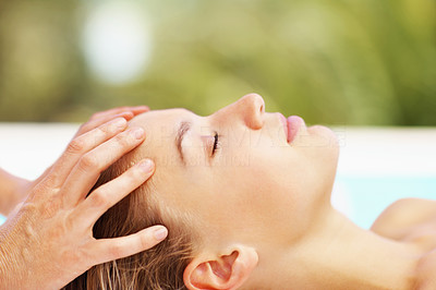 Closeup image of a female receiving a head massage