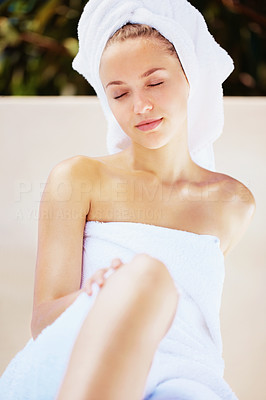 Young relaxed female in towel after a bath wrapped in a towel