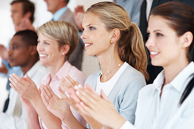 Business woman with colleagues applauding at a seminar