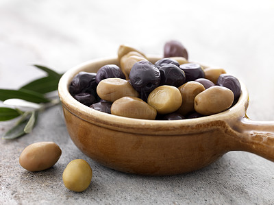Dried black and green olives in a bowl