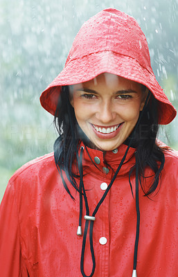 Woman smiling while standing in rain