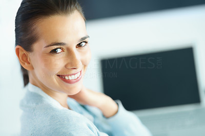 Woman smiling with laptop in background