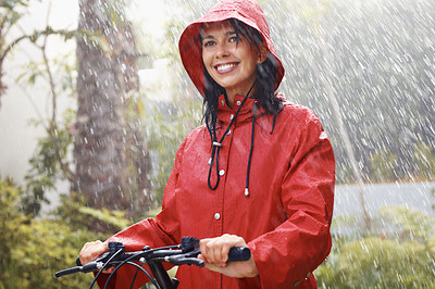 Woman in raincoat going for bike ride