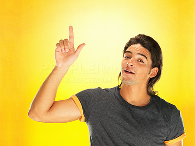 Attractive man pointing up