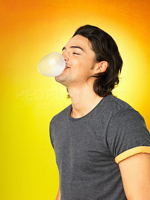 Attractive man blowing bubble