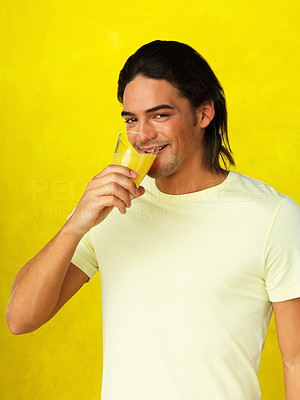 Flirtatious man drinking orange juice