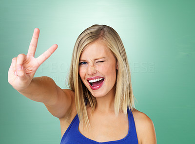 Smiling woman giving peace sign