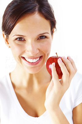 Young brunette woman holding red apple on white