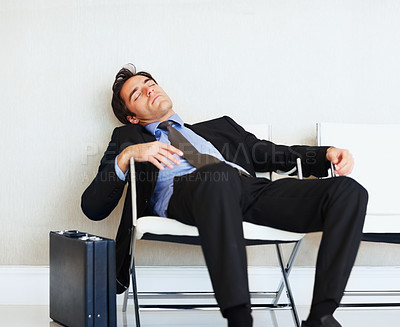 Bored business man sleeping on chair with copyspace
