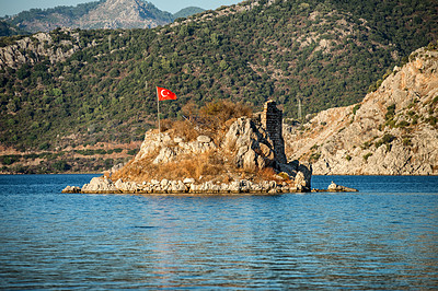 Small island in a large lake with the flag of Turkey