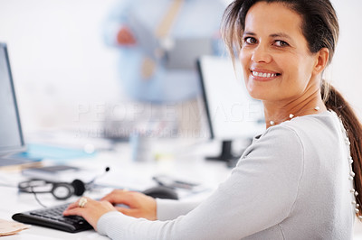 Mature business woman using computer in office