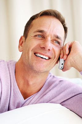 Smiling mature man using cell phone