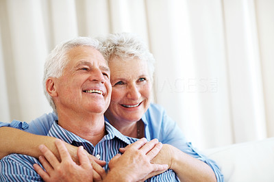 Smiling old couple looking away at copyspace