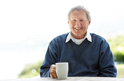 Active senior man holding a cup of coffee